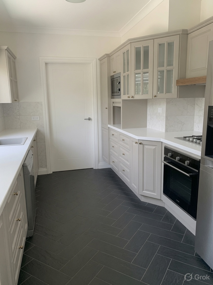 Soft painted cabinets, white epoxy, dark herringbone floor.